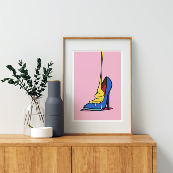 Framed colorful shoe art print standing on a dresser - Solleveld & Toim art prints shop